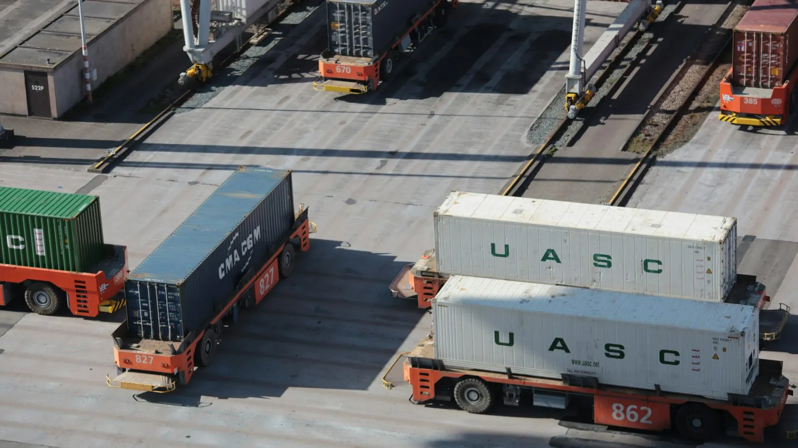 Container terminal yard with stacked containers and terminal tractors